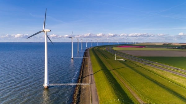 Wind turbines next to a coastline