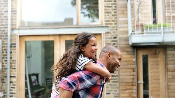 Father giving daughter a piggy-back