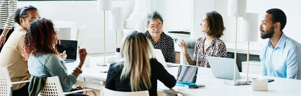 Colleagues talking around an office table