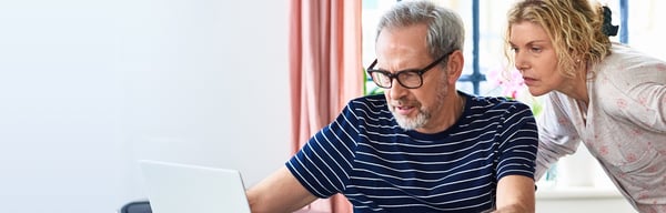 Couple staring at laptop screen