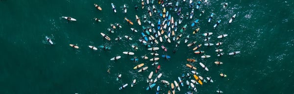 Surfers paddling out