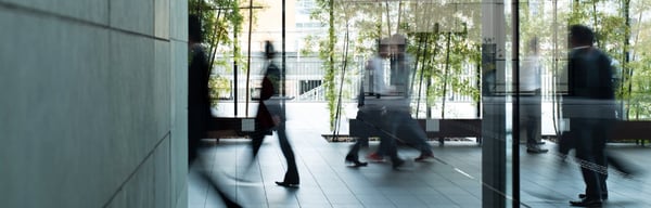 People walking through an office building